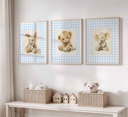 Set of three nursery prints with vintage-style stuffed bunny, lion cub, and elephant sitting on a light blue gingham background