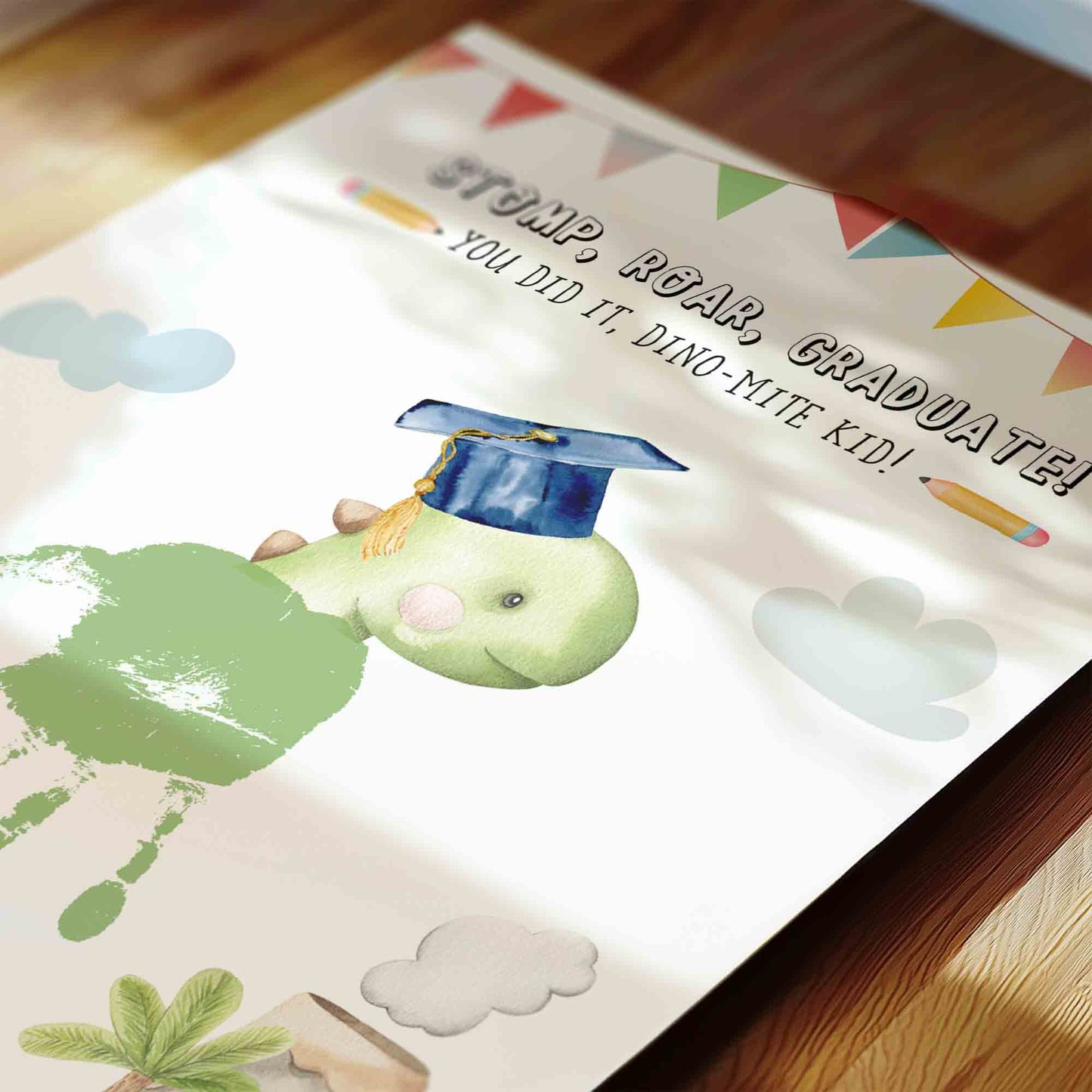 Graduation-themed children's mat with dinosaur illustration and text on a wooden floor.