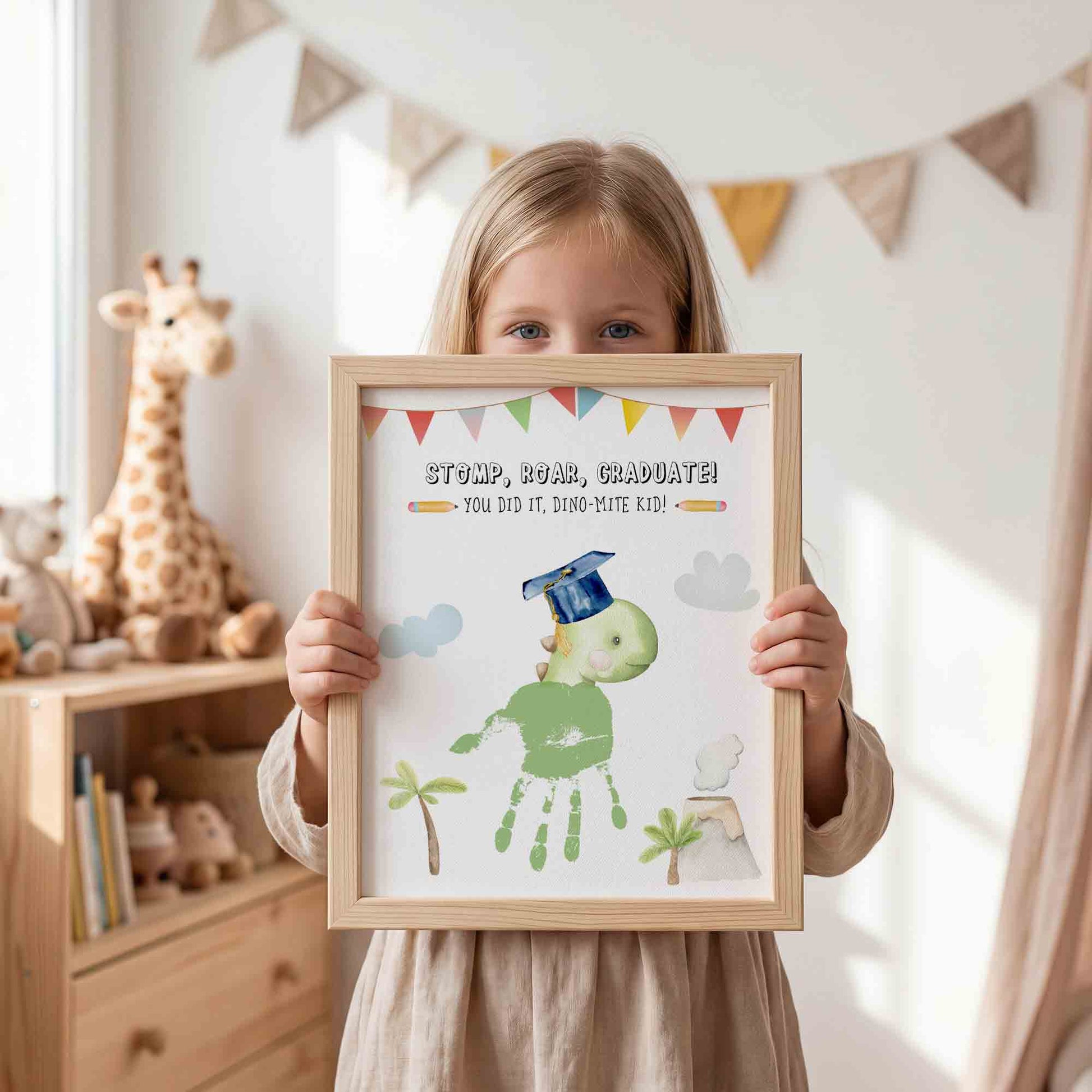Child holding a framed print with a dinosaur graduate design in a room with toys and decorations.