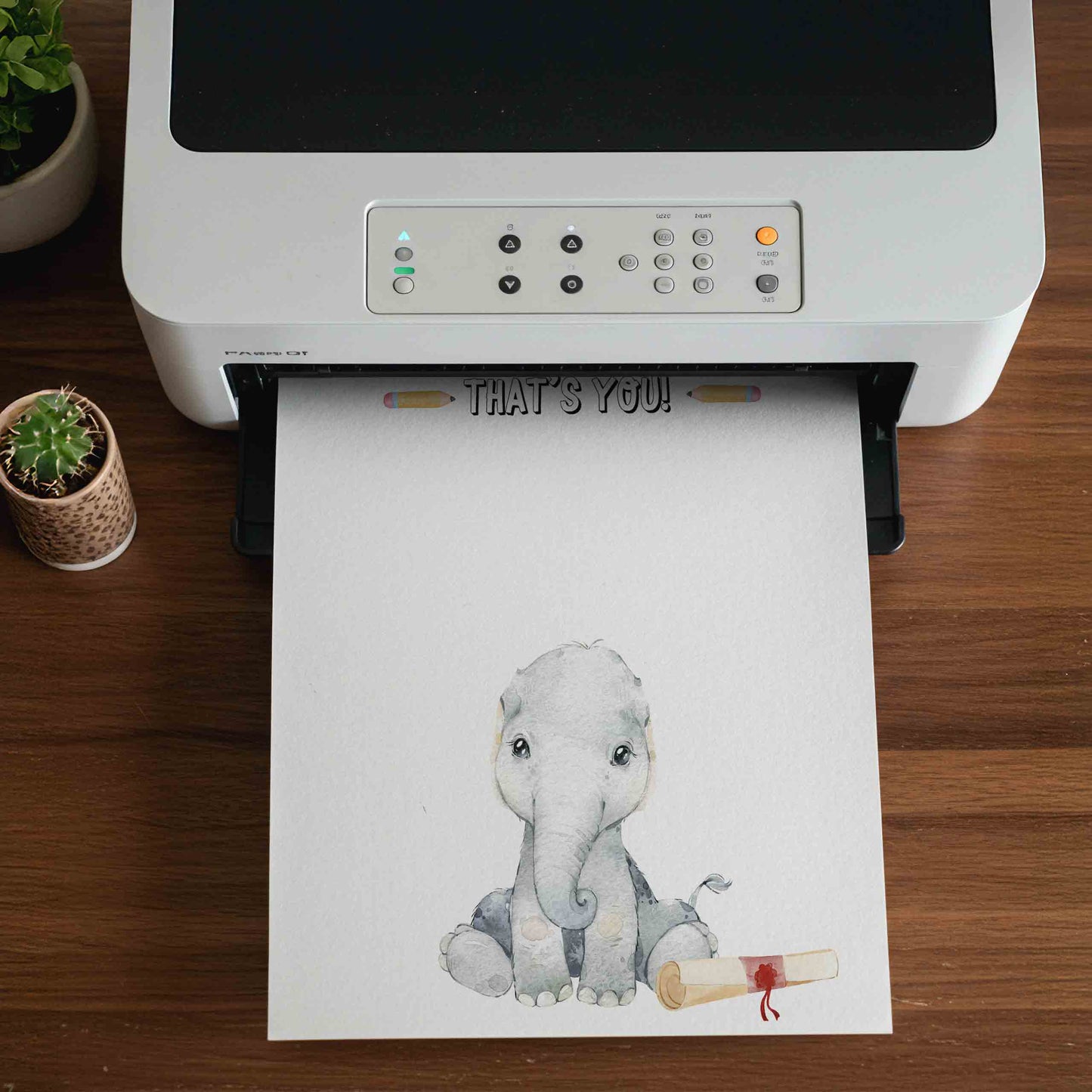 Printer on a wooden surface with a printed sheet featuring an elephant and diploma.