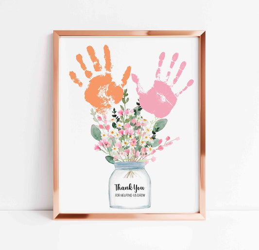 Framed artwork with handprints and flowers on a white background