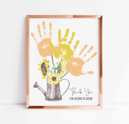 Framed artwork with handprints and a watering can on a white background