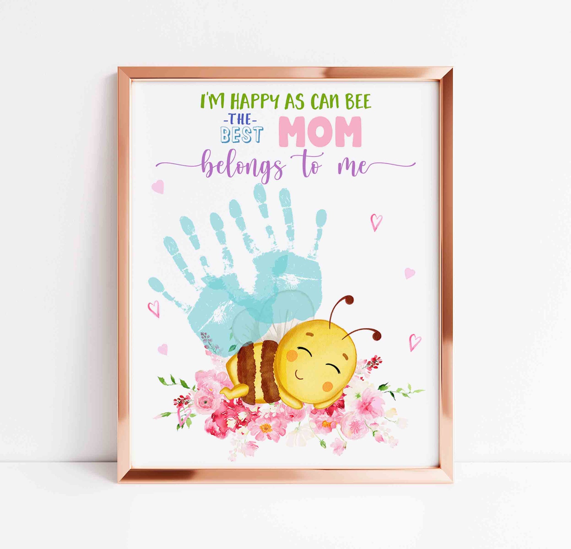 Framed artwork with a bee, handprint, and text on a white background
