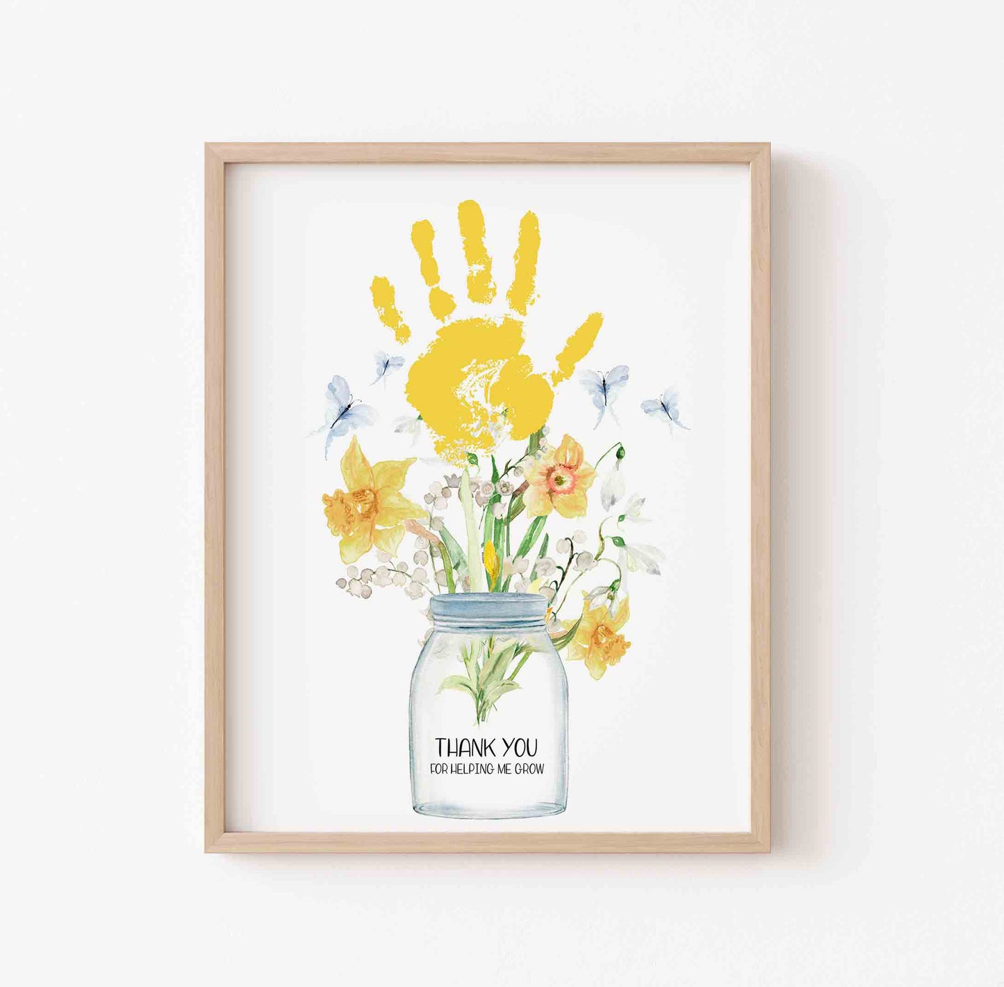 Framed artwork with a yellow handprint and flowers in a jar on a white background