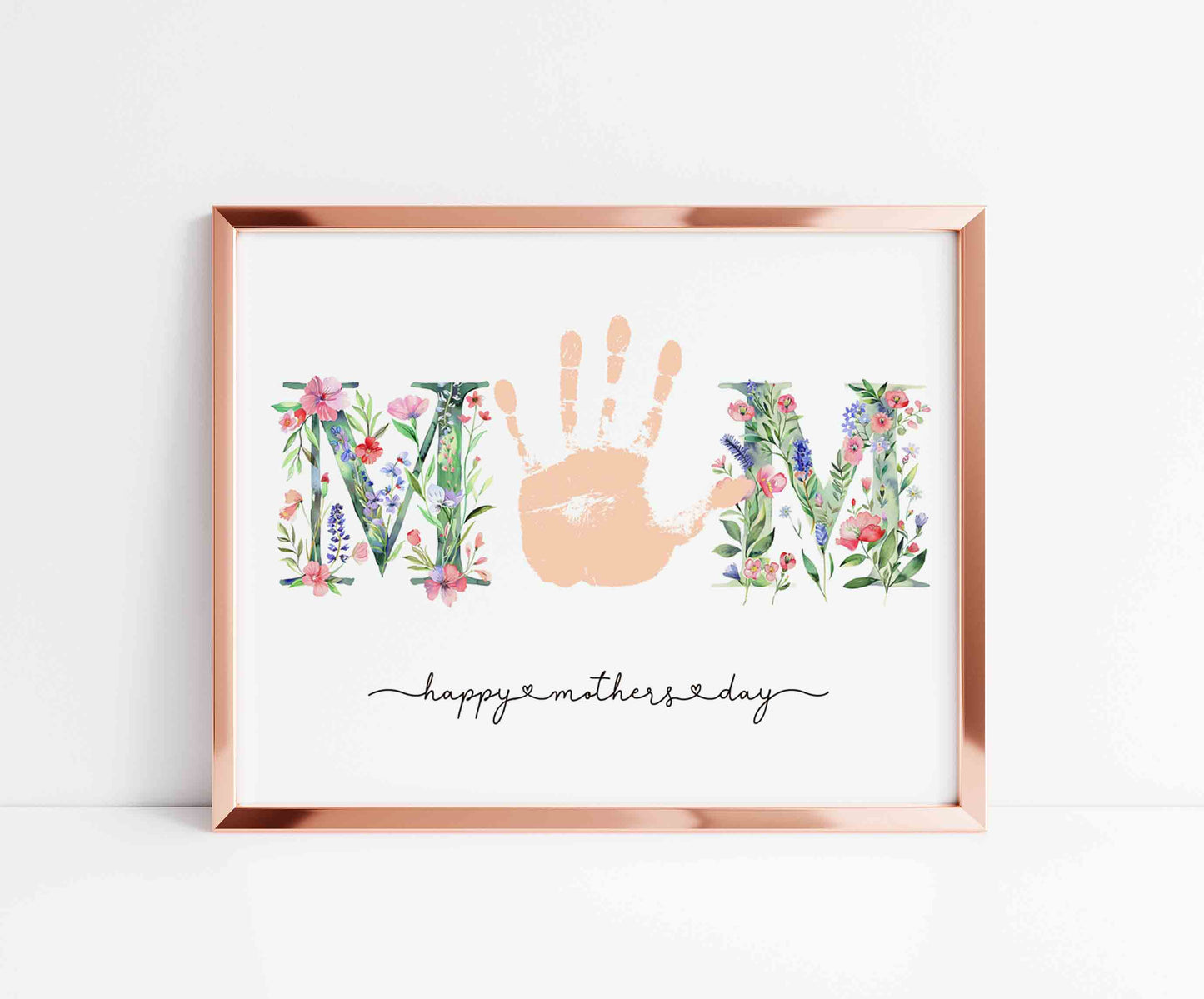 Framed artwork with 'MOM' handprint and floral elements on a white background