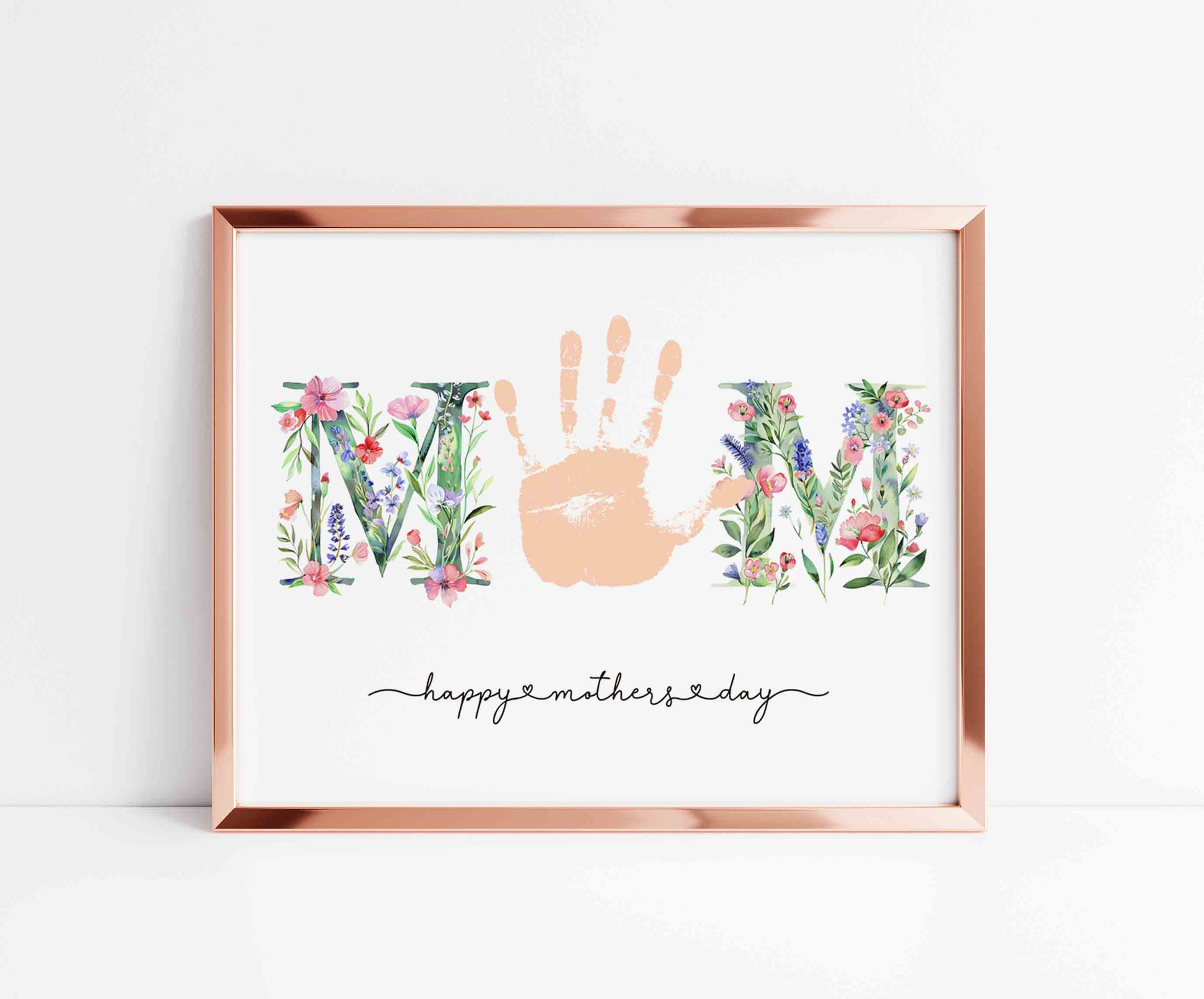 Framed artwork with 'MOM' handprint and floral elements on a white background