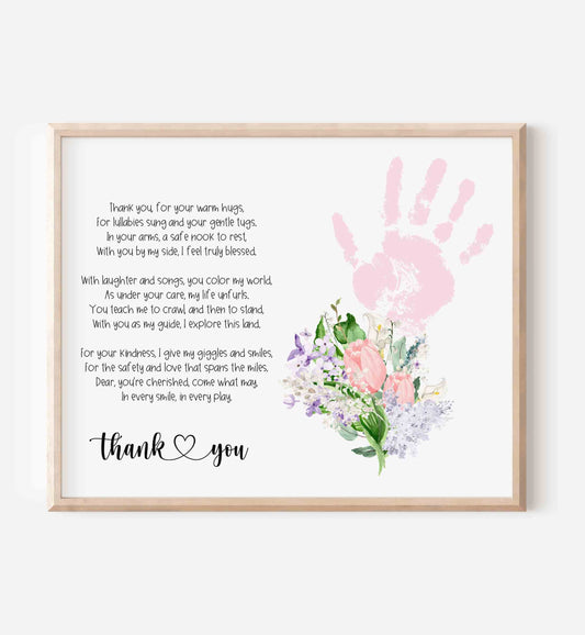 Framed print with pink handprint, flowers, and text on a white background