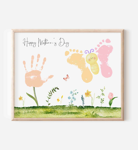 Framed artwork with hand and foot prints, flowers, and 'Happy Mother's Day' text on a white background.