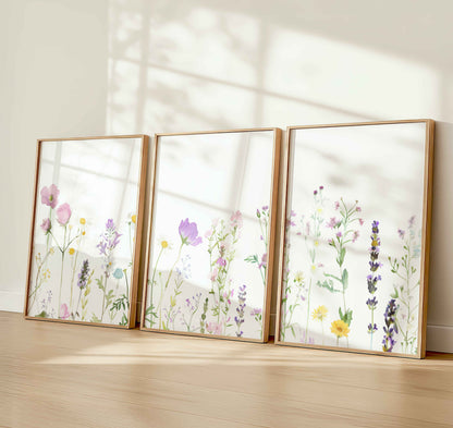 Set of 3 wildflower nursery prints with watercolor-style pastel flowers in soft sunlight, ideal for baby girl or botanical wall décor.