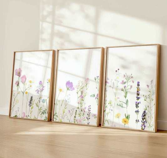 Set of 3 wildflower nursery prints with watercolor-style pastel flowers in soft sunlight, ideal for baby girl or botanical wall décor.
