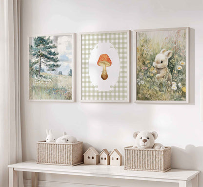 Three-piece cottagecore nursery art set featuring watercolor pine tree landscape, red spotted mushroom on sage gingham background, and bunny in wildflower meadow in white wooden frames
