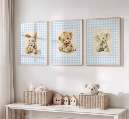 Set of three nursery prints with vintage-style stuffed bunny, lion cub, and elephant sitting on a light blue gingham background
