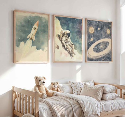Vintage nursery wall art set with an astronaut floating in space, a rocket flying in a starry sky, and planets including Saturn and multiple moons on a blue striped background

