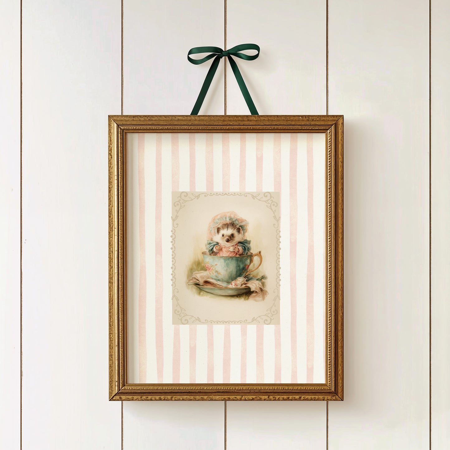 Printable wall art of a vintage hedgehog in a teacup with bonnet and books, pink striped background, cottagecore woodland nursery décor.