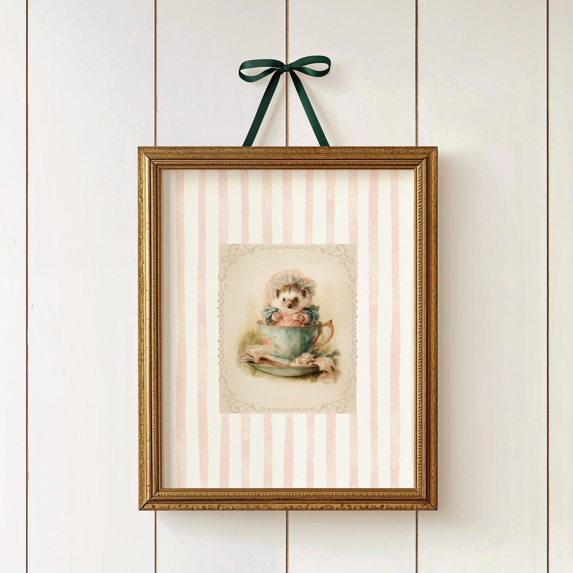 Printable wall art of a vintage hedgehog in a teacup with bonnet and books, pink striped background, cottagecore woodland nursery décor.