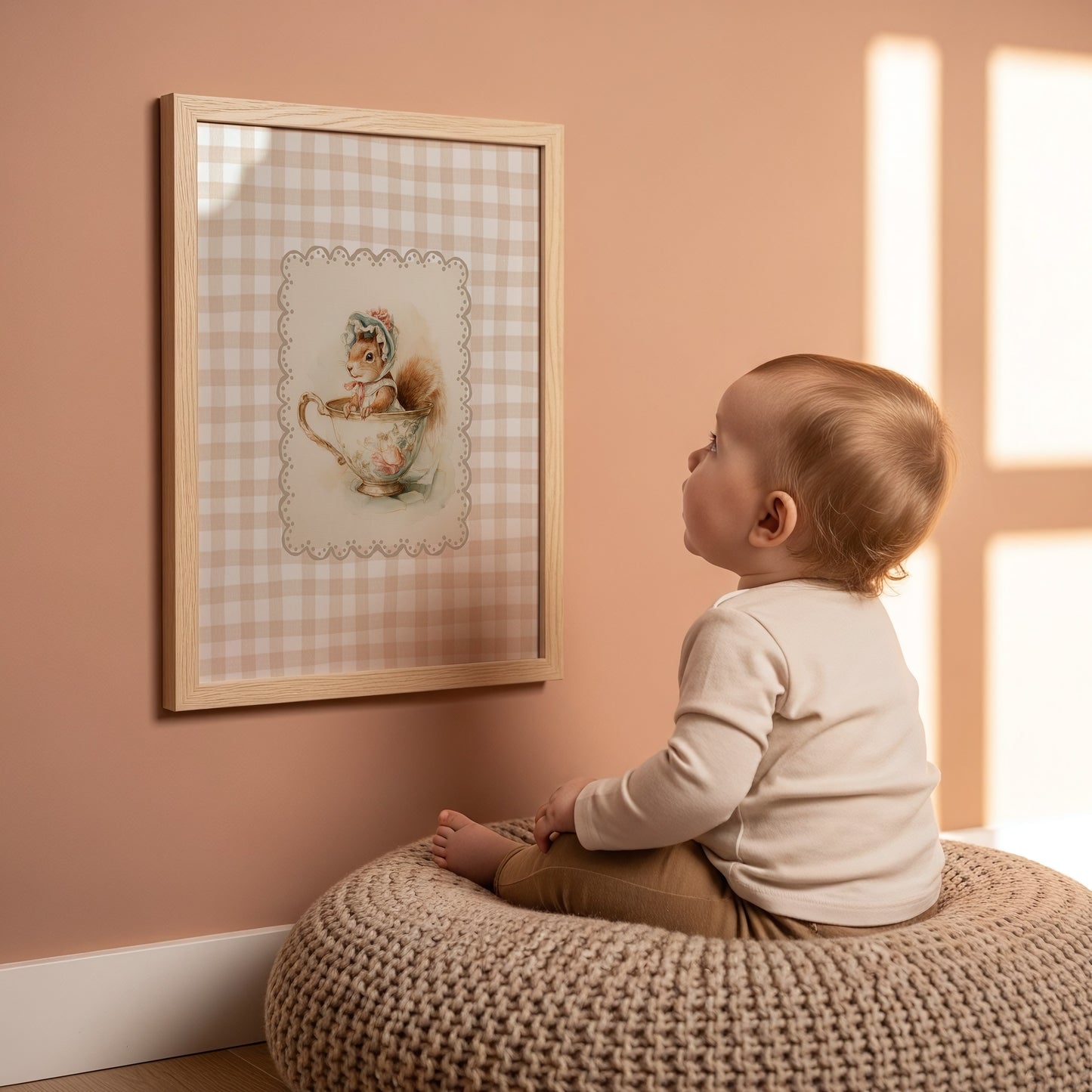 Child sitting on a woven stool looking at a framed picture on a pink wall