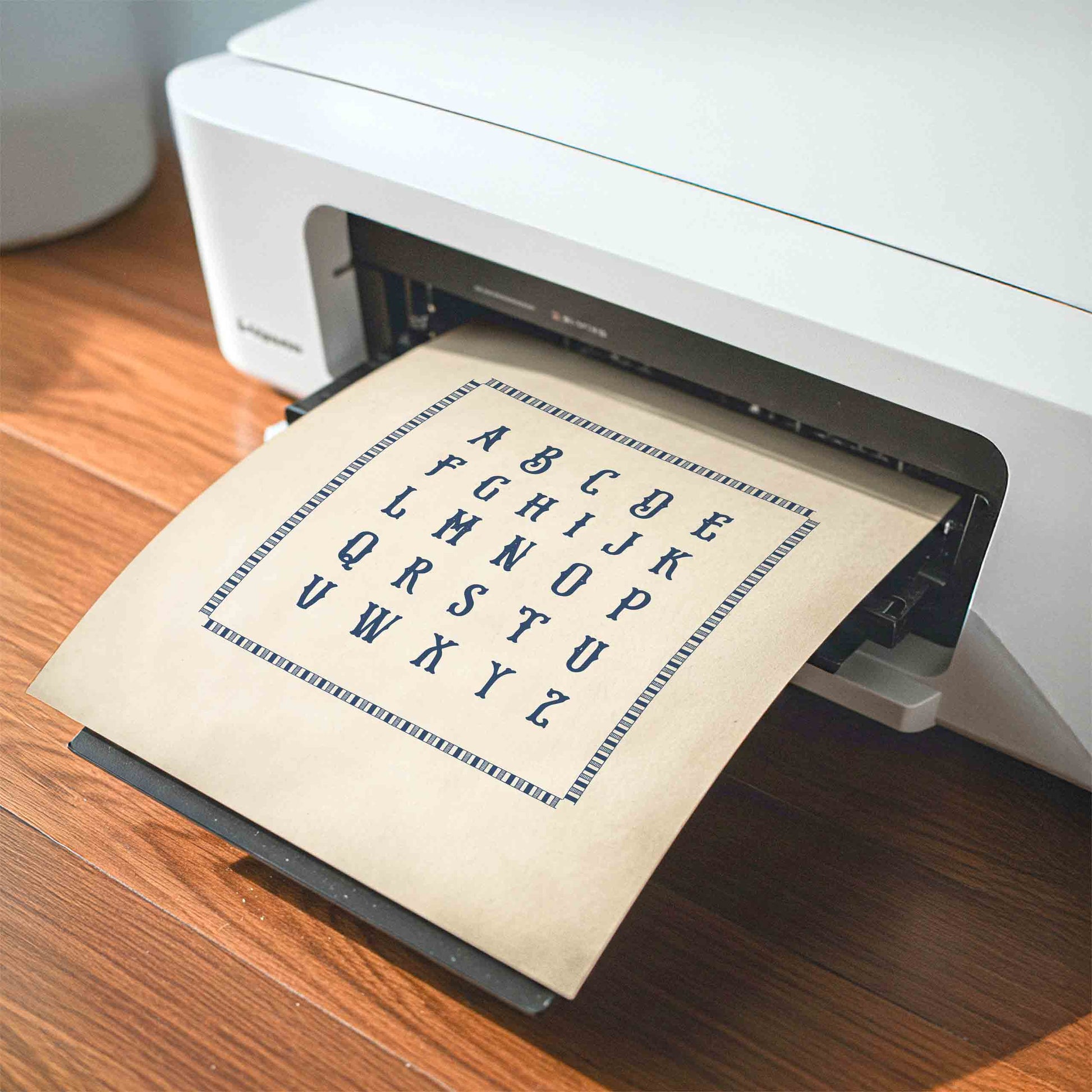Hand lettered alphabet chart print styled being printed for a baseball nursery room