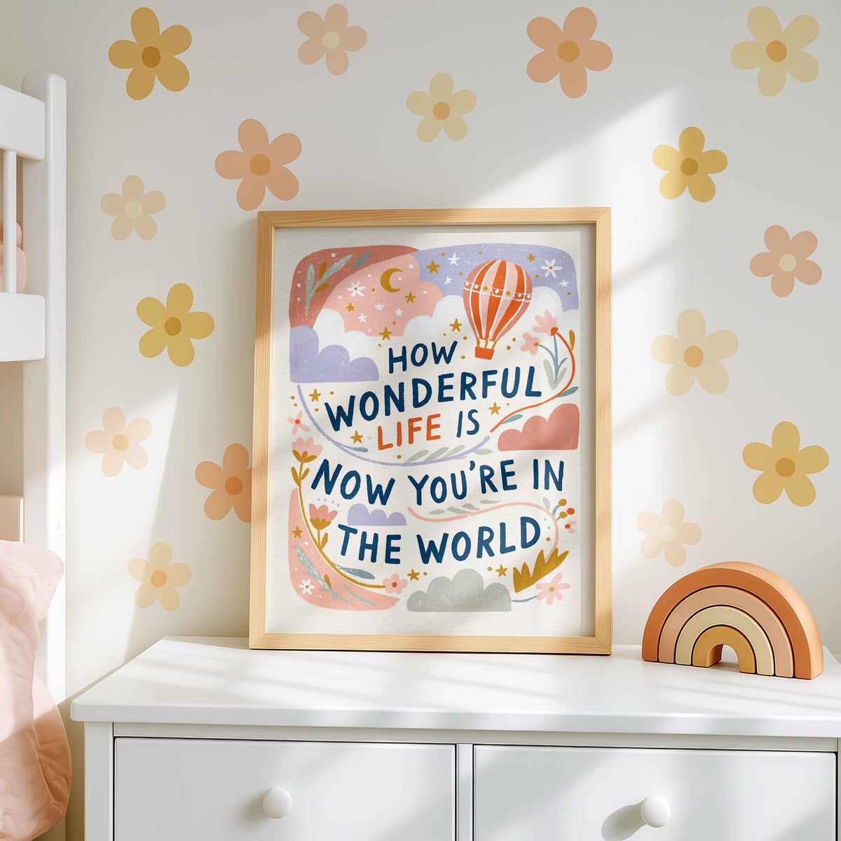 Retro wall art pairing a striped orange balloon with clouds, golden stars and a crescent moon