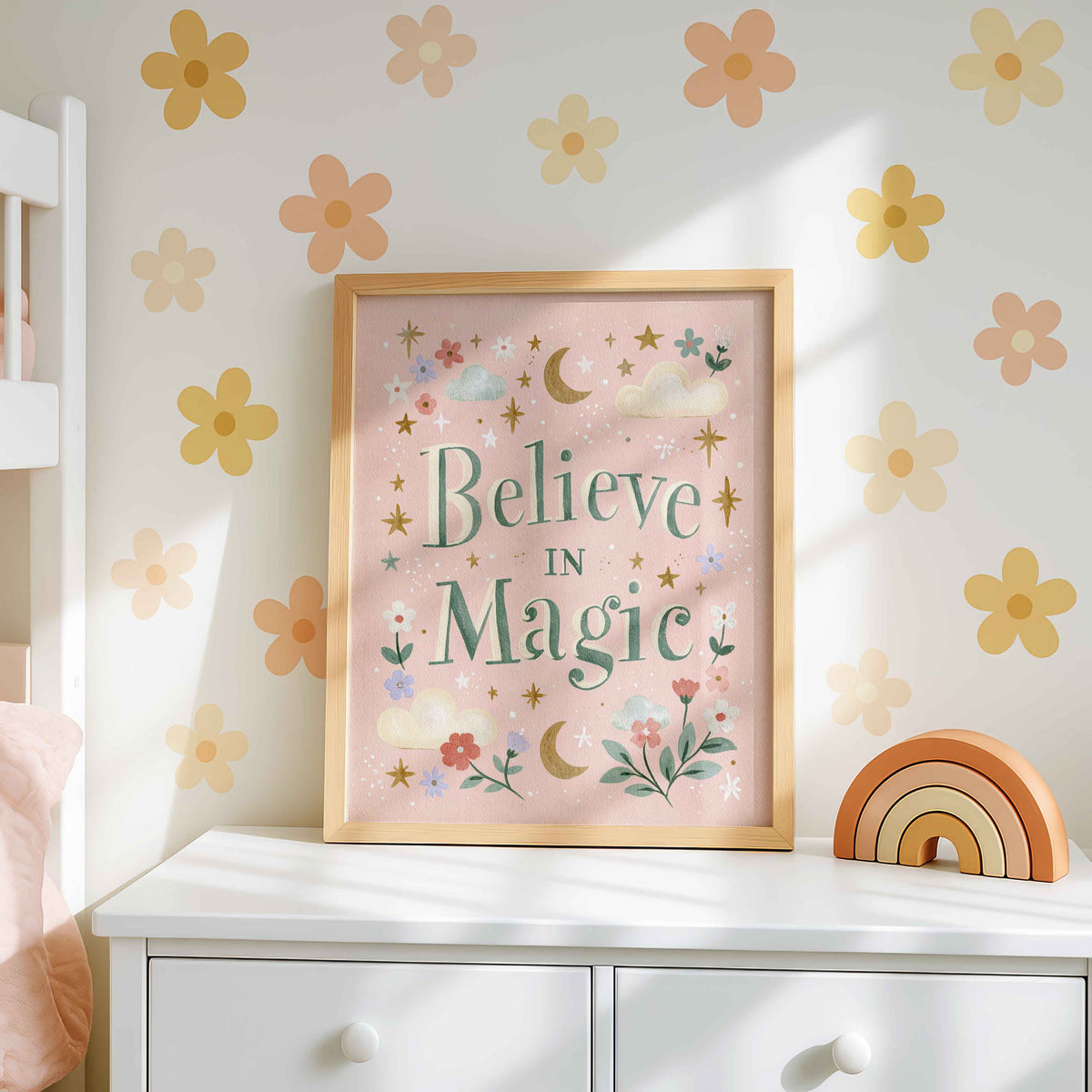 Retro wall art pairing green lettering on a rosy pink field with crescent moons and twinkling stars