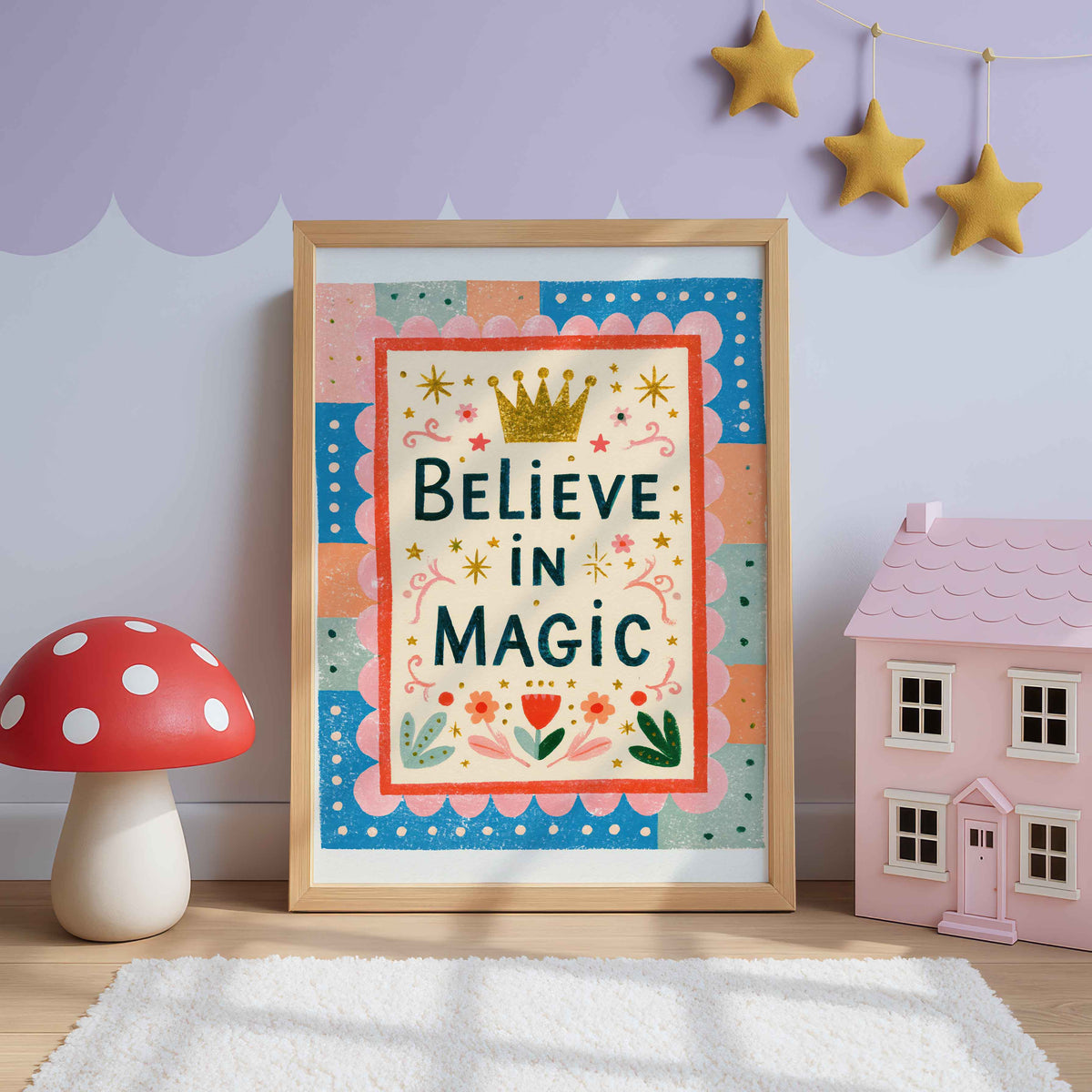 Retro wall art with a golden crown above Believe In Magic in navy lettering inside a scalloped pink border