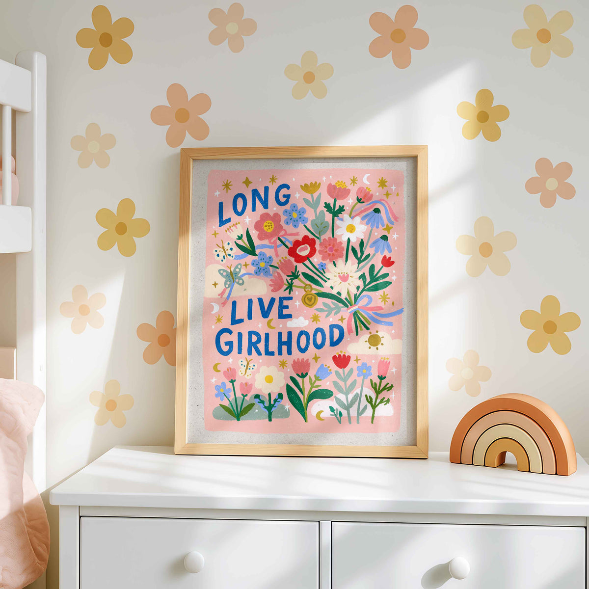 Retro wall art pairing a bouquet tied with pink and blue ribbons with butterflies and little crescent moons